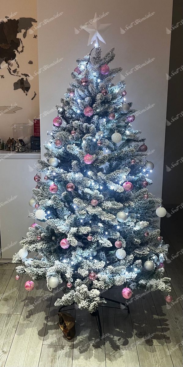Umelý vianočný stromček Smrek Severský 180cm je ozdobený bielymi  a ružovými ozdobami.